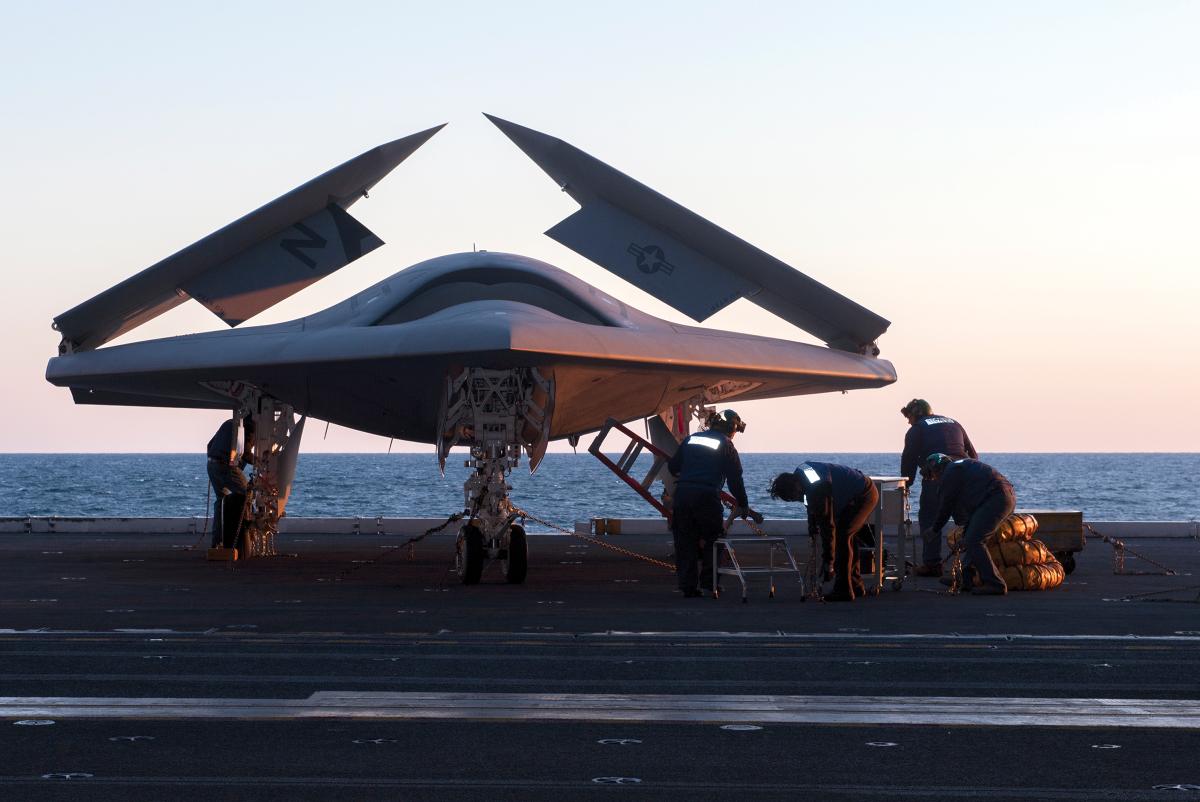 A Lockheed Martin X-47 unmanned combat air vehicle on an aircraft elevator on board the USS George H. W. Bush (CVN-77) in 2013, before the X-47 became the first fixed-wing unmanned aircraft to launch and recover from an aircraft carrier.