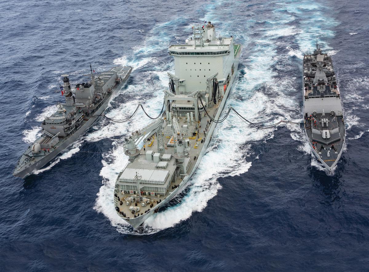 Chilean and Indian Navy Frigates perform replenishment at sea with a Royal Canadian Navy supply ship.