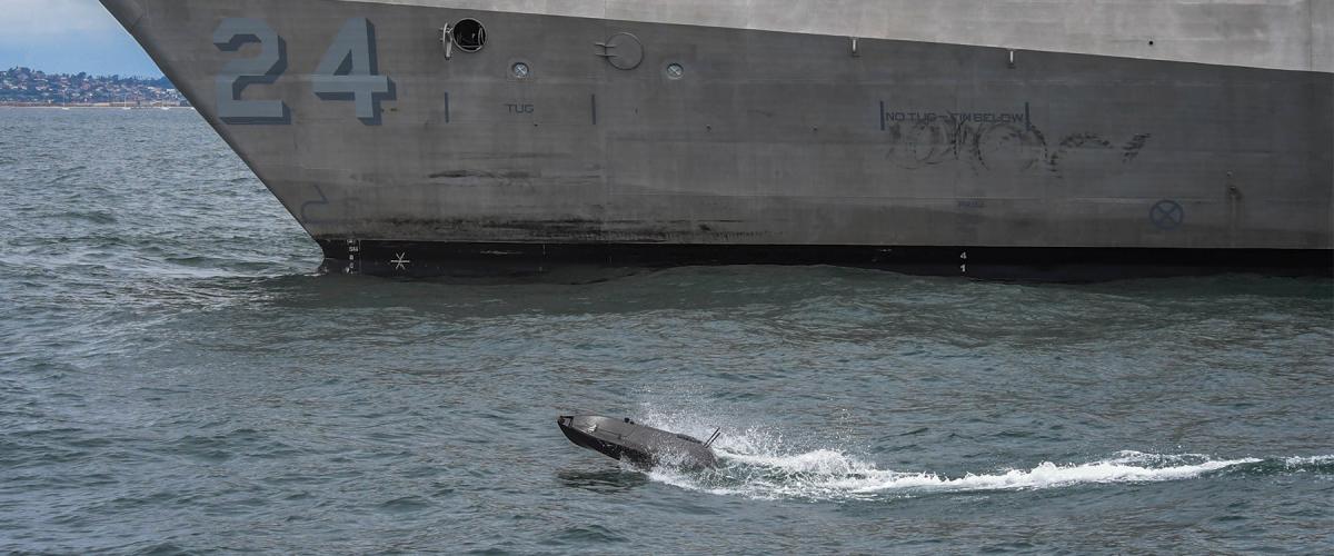 An ADARO unmanned system operating near the USS Oakland (LCS-24) during the Pacific Fleet’s Unmanned Integrated Battle Problem 21, which tested integration of manned and unmanned capabilities.