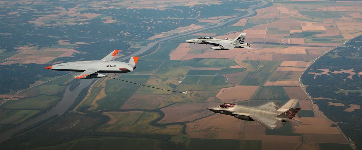 uncrewed MQ-25 Stingray refuels a manned F-35C joint strike fighter