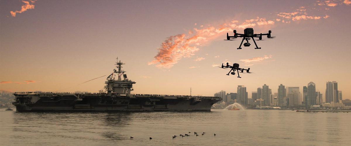 In this conceptual image, two small unmanned aerial vehicles race toward the USS Abraham Lincoln (CVN-72) as she transits the San Diego bay.