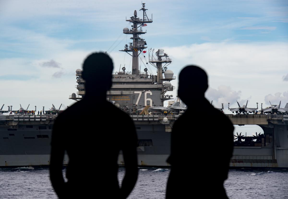Navy Sailors observe the USS Ronald Reagan from the USS Nimitz. 