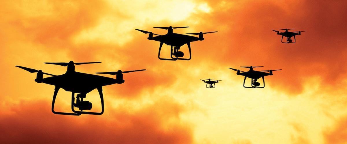 Drones against a cloudy orange sky
