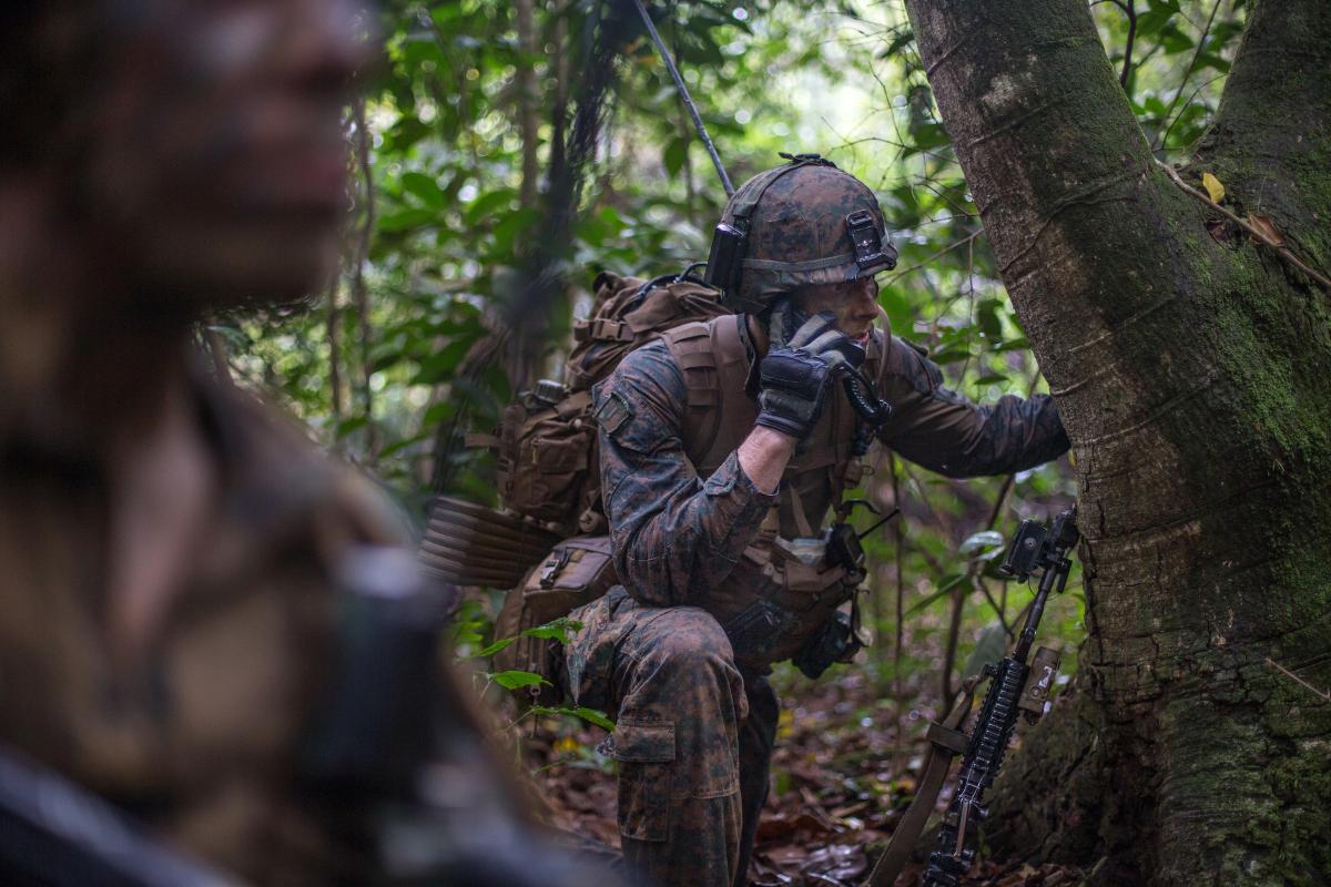 A U.S. Marine platoon commander gives orders over the radio during Exercise Valiant Mark 2019 on Tekong Island, Singapore.
