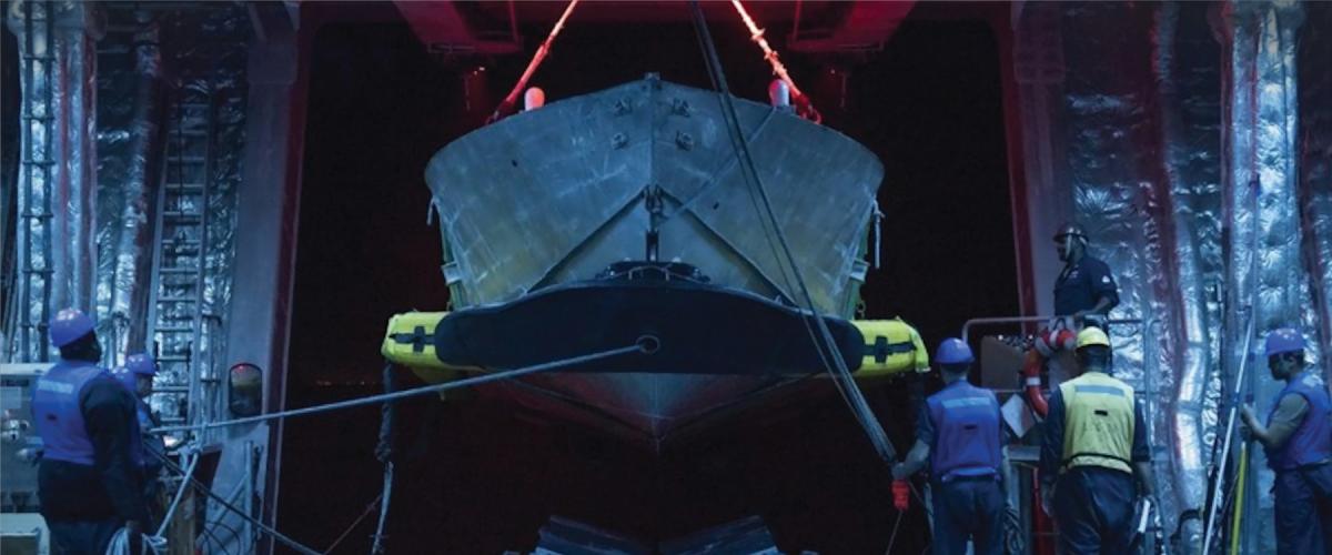 Sailors practice mine countermeasures unmanned surface vessel launch and recovery in the  mission bay of the Independence-variant littoral combat ship USS Cincinnati (LCS-20). The Navy should develop a robust unmanned capability dedicated to mine countermeasures.
