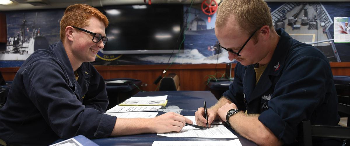 Sailors on board the USS Philippine Sea (CG-58) fill out paperwork for absentee voting. Nothing shows you care about the voice of your sailors more than encouraging them to vote.