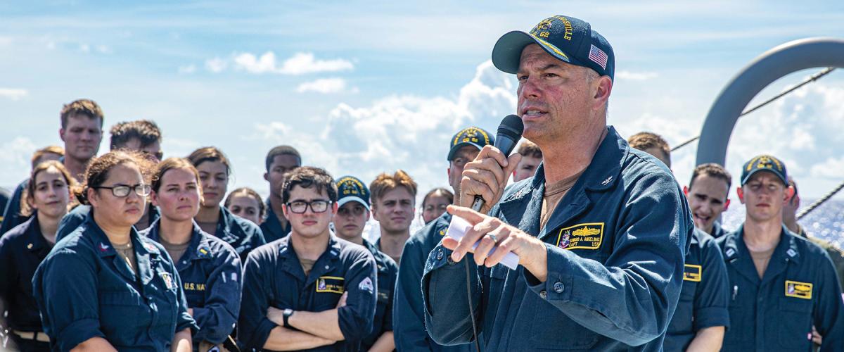 A commanding officer speaks to his crew during an all-hands meeting