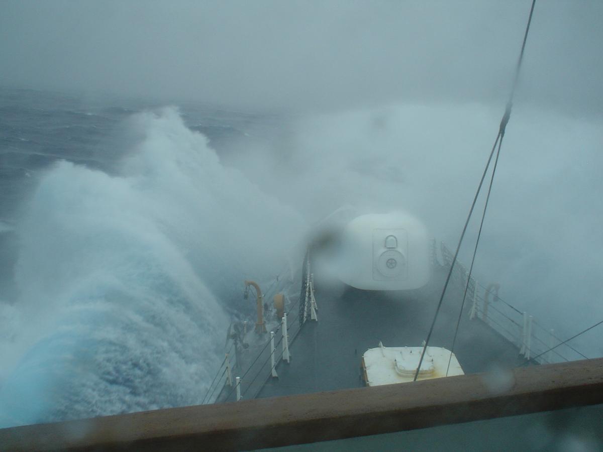 View looking down the bow of the USCGC Midgett (WHEC-726) as it breaks through heavy seas