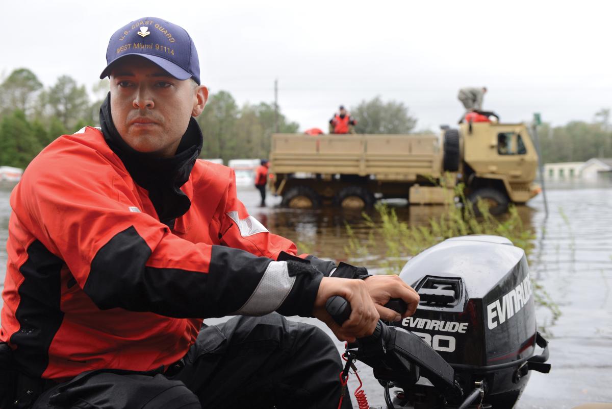 A member of Coast Guard Maritime Safety and Security Team Miami drives a shallow-water craft through floodwater caused by Hurricane Florence