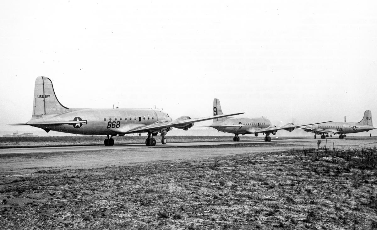 Two R5Ds of Naval Air Transport Squadron 8 (VR-8) sandwich an Air Force C-54 as they await their turn for takeoff from Rhein-Main Air Base in January 1949