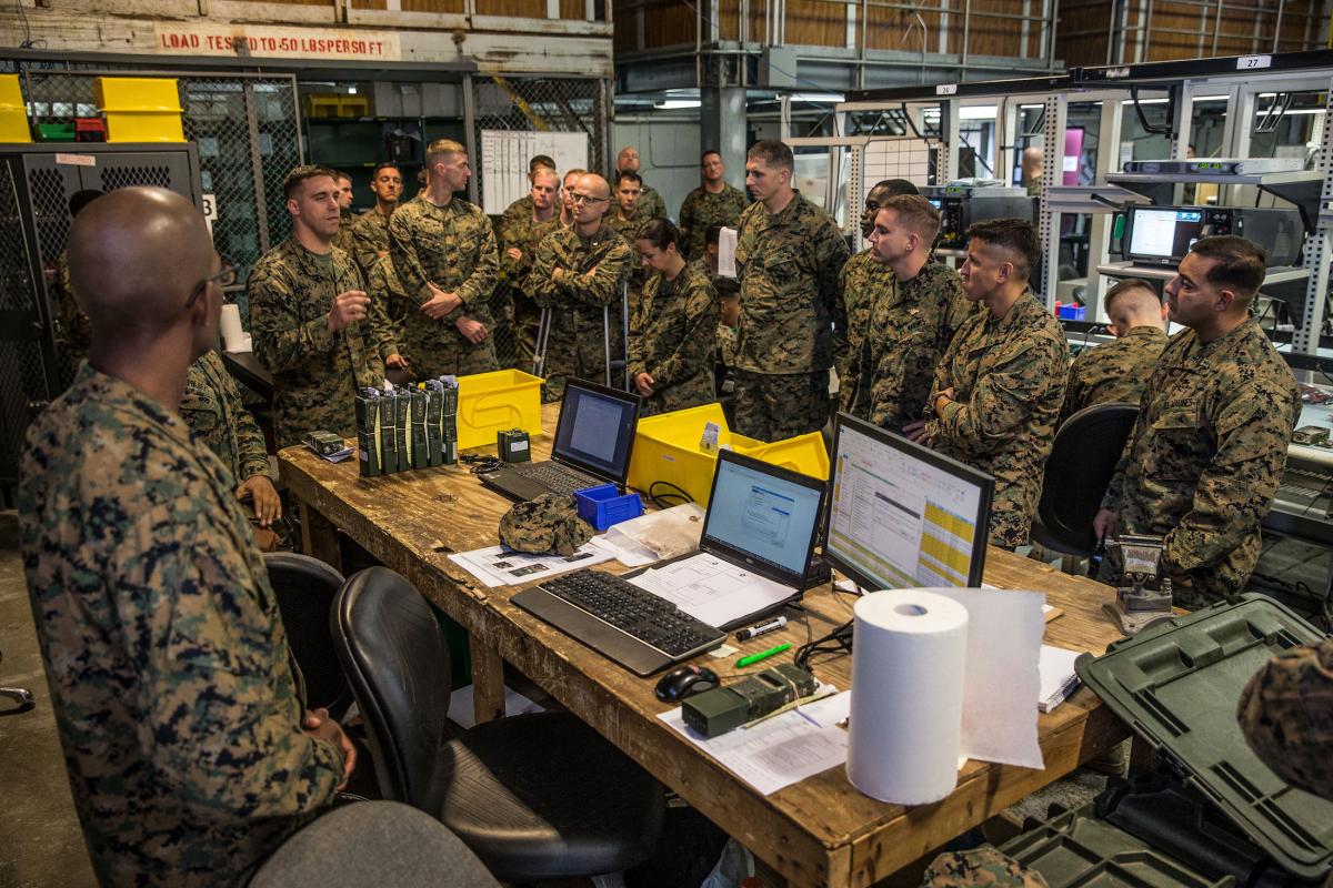 Marine students at the Expeditionary Warfare School tour a maintenance facility in Camp Pendleton, California.
