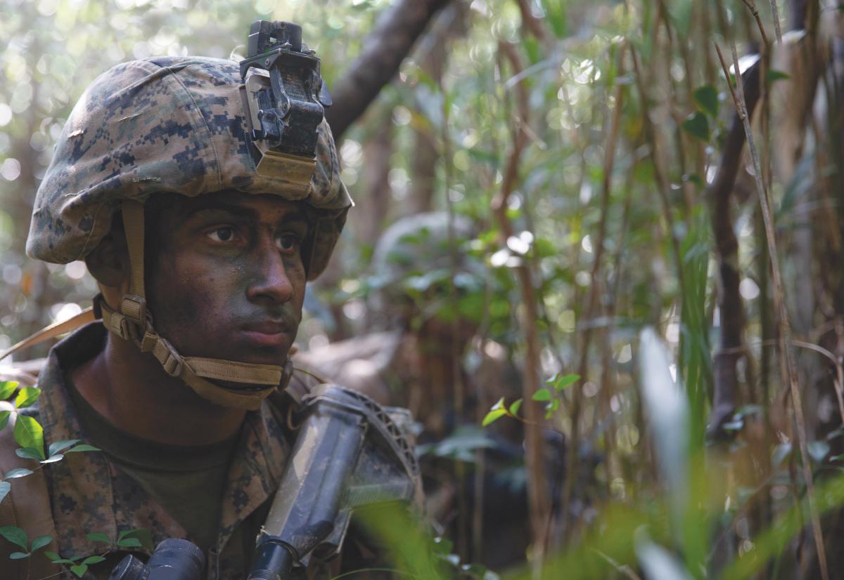 A U.S. Marine scans the area at the Jungle Warfare Training Center (JWTC), Camp Gonsalves, Okinawa, Japan, on Mar. 12, 2019