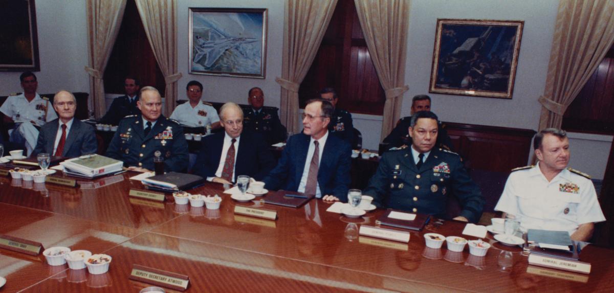 15 August 1990: President George H. W. Bush meets with the Joint Chiefs of Staff in the Pentagon to discuss the military response to the Iraqi invasion of Kuwait. (L. to r.: National Security Advisor Brent Scowcroft; General H. Norman Schwarzkopf, Commander-in-Chief U.S. Central Command; Secretary of Defense Dick Cheney; President Bush; General Colin Powell, Joint Chiefs Chairman; and Admiral David E. Jeremiah.)