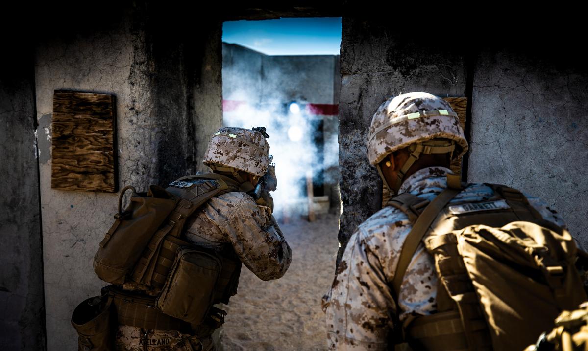 Marines from 1st Battalion, 7th Marine Regiment, clear a building at the Twentynine Palms Military Operations on Urban Terrain (MOUT) Center.  Such facilities can be better for training than operational testing, because restricted military training grounds lack robust civilian populations or major urban centers and are not representative information environments.