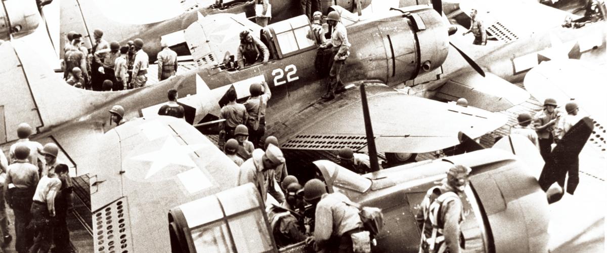 Pilots and gunners of Bombing Squadron 16 (VB-16)  climb out of their Douglas SBD-5 bombers onto the flight deck of the USS Lexington after returning from the Tarawa-Makin raid, 18 September 1943.