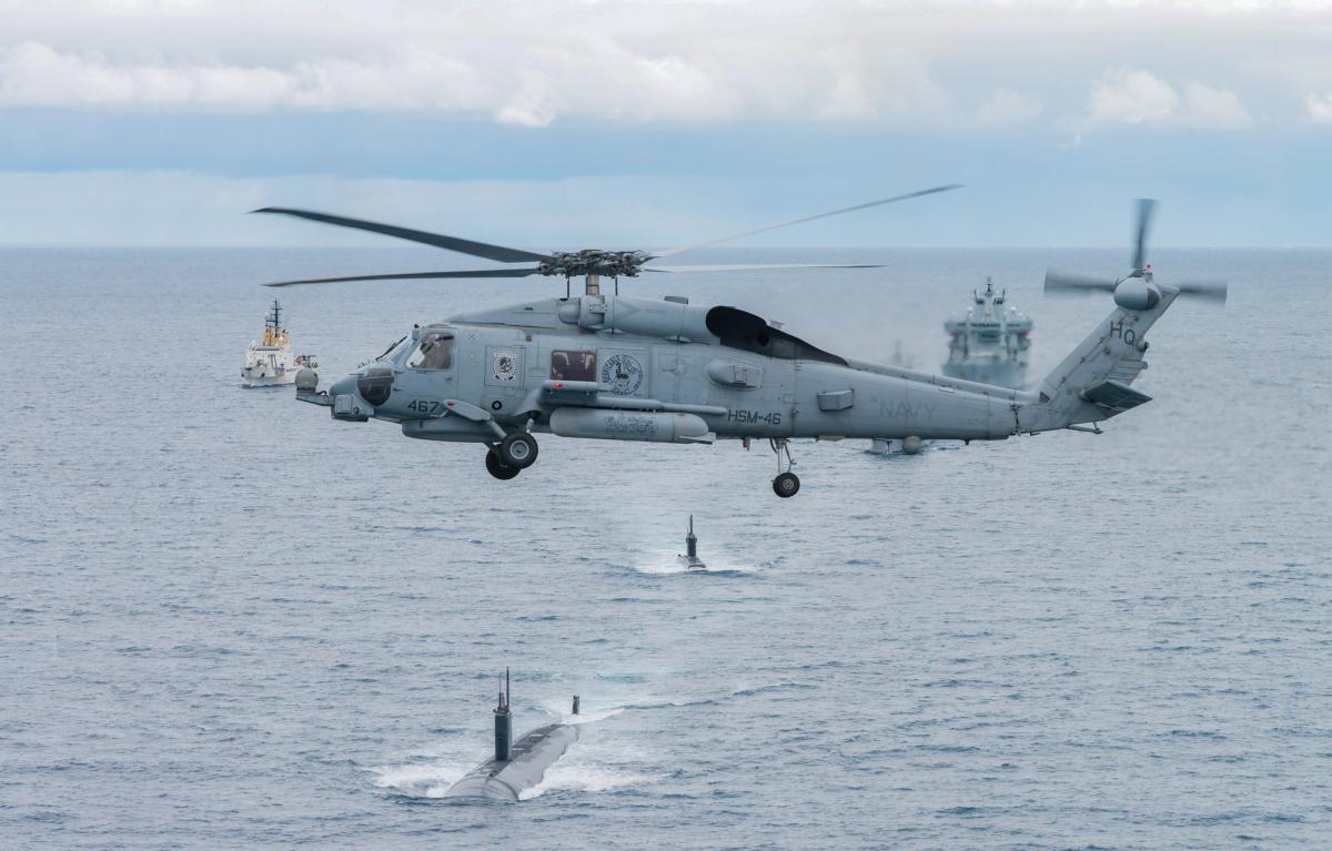US. Navy Seahawk helicopter flies over USS Toledo and HNoMS Ures submarines as they participates in Dynamic Mongoose