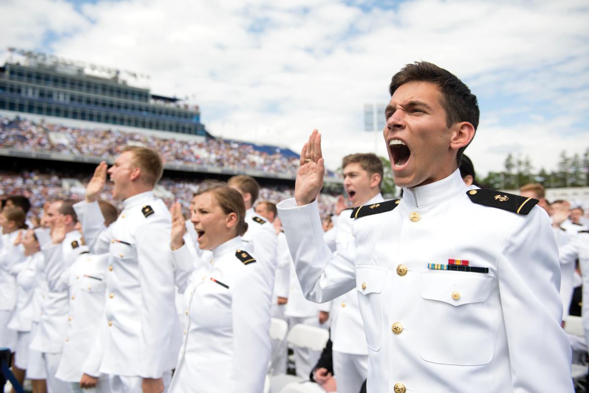 U.S. Naval Academy midshipmen take the oath of office to become Navy officers during the graduation and commissioning ceremony