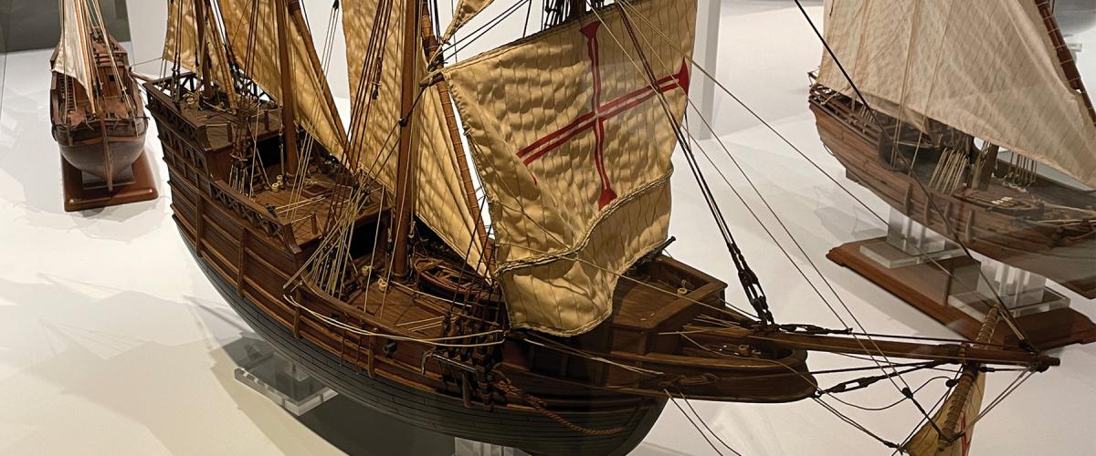 The museum is bursting with artifacts, exquisite ship models, navigation tools, weapons, uniforms, and maps. Display descriptions are in Portuguese and English.