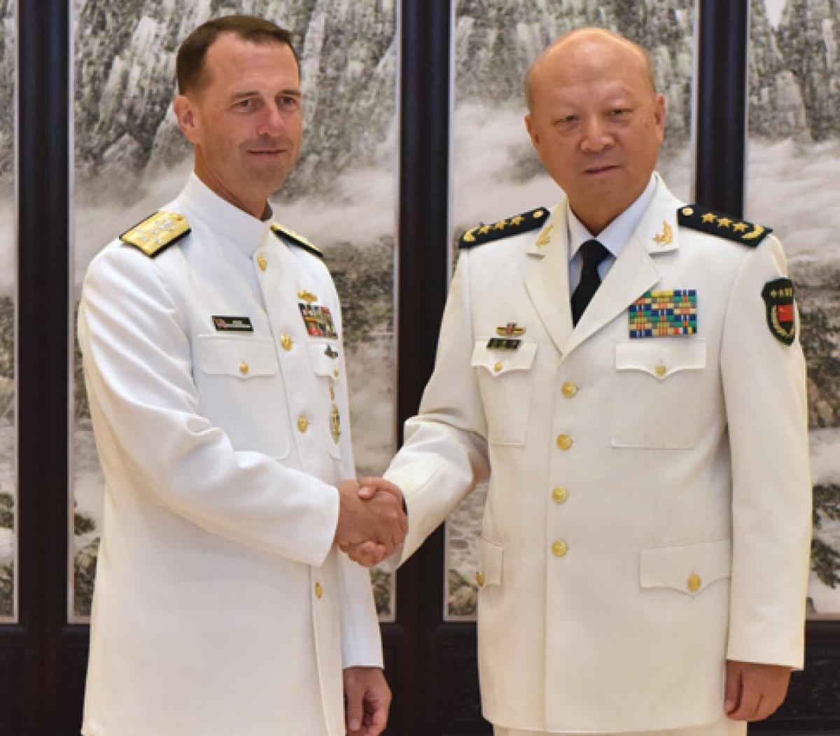 CNO Admiral John Richardson (left) shakes hands with Admiral Wu Shengli, Commander of the PLAN, at Chinese Navy Headquarters in Beijing during a July visit—just five days after the Permanent Court of Arbitration ruled against China in a South China Sea island territorial dispute. What signals do such engagements send to longtime U.S. allies?
