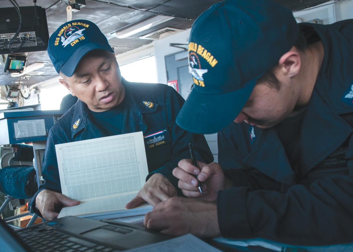  Senior Chief Engineman Jason Saffa mentors Engineman Second Class Quanesha Jenkins on board the USS Rushmore (LSD-47) while deployed.