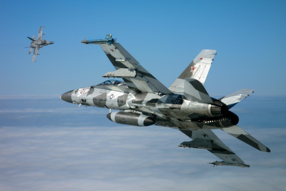 A Fighter Squadron Composite (VFC) 12 F/A-18 Super Hornet takes on another Hornet of Strike Fighter Squadron (VFA) 204