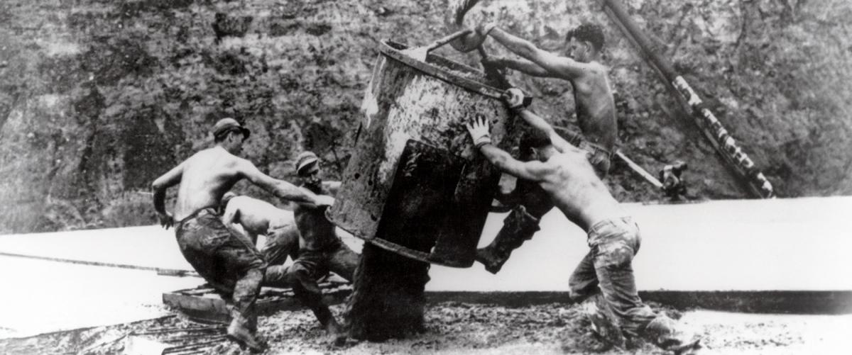 Seabees unload a concrete bucket at Cubi Point, the Philippines. In the 1950s, Seabees built Cubi Point Naval Air Station—something civilian contractors claimed was impossible given the mountainous, jungle-covered terrain.
