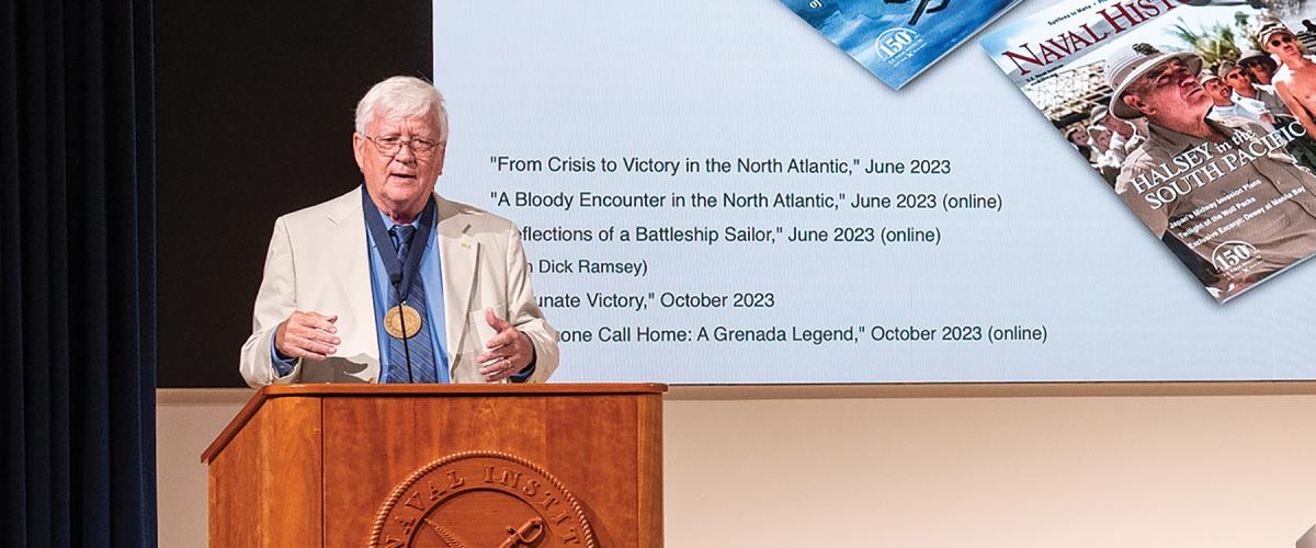 Ed Offley addresses the audience at the U.S. Naval Institute’s Annual Meeting after receiving the Naval History Author of the  Year medal.