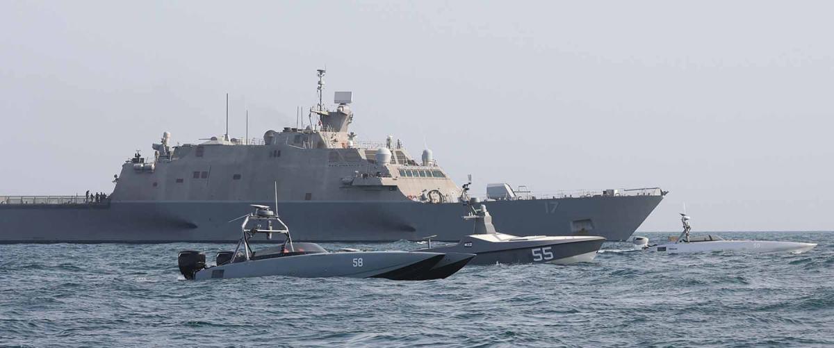 The USS Indianapolis (LCS-17) sails with unmanned surface vessels in the Arabian Gulf. Rather than decommissioning the littoral combat ships, the Navy should install the lethality and survivability upgrades that have been proposed.