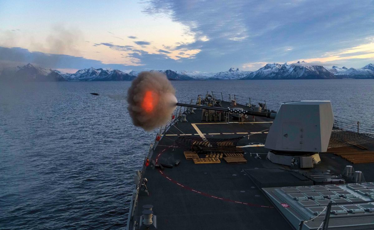 A destroyer fires its Mark 45 5-inch gun.