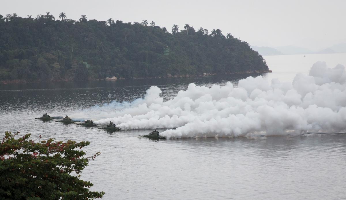 Brazilian amphibious assault vehicles lay smoke