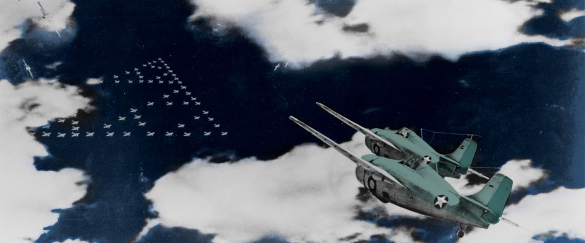 A pair of F4F-3 Wildcat fighters of Marine Aircraft Group (MAG) 22 head toward the enemy’s formation of Midway-bound bombers early on 4 June 1942.  Of MAG-22’s 26 fighter pilots who took off that morning, 14 later would be missing in action.