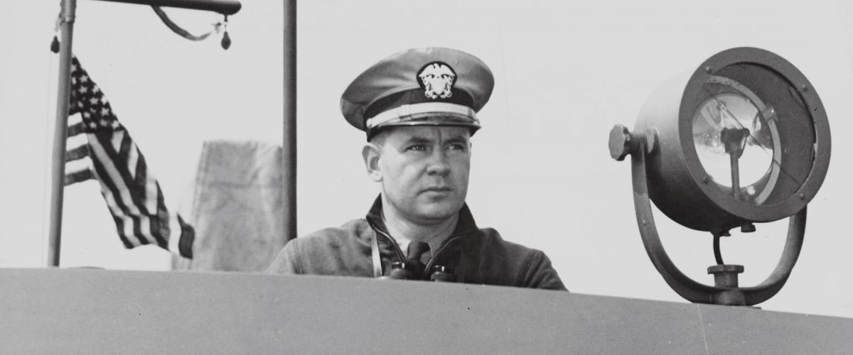 Bulkeley, commander of PT Squadron Three, shown on the bridge of a PT boat during the Battle of the Philippines.
