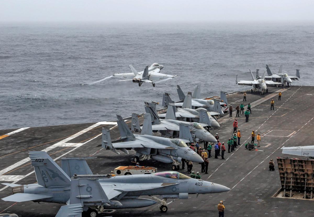 An F/A-18 Super Hornet attached to Strike Fighter Squadron 143 launches from the flight deck of the USS Abraham Lincoln (CVN-72) in the U.S. Fifth Fleet area of operations
