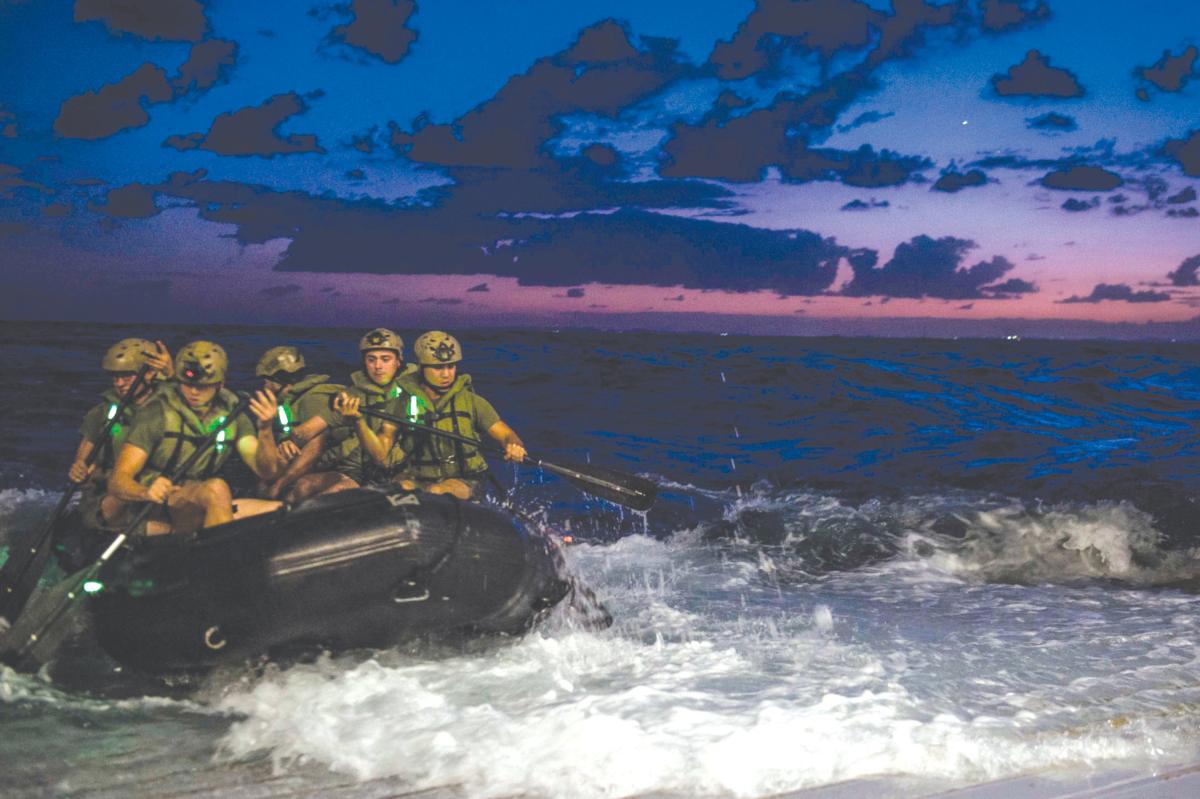 Marines depart the well deck of the amphibious transport dock ship USS Green Bay (LPD 20) in a combat rubber raiding craft (CRRC)