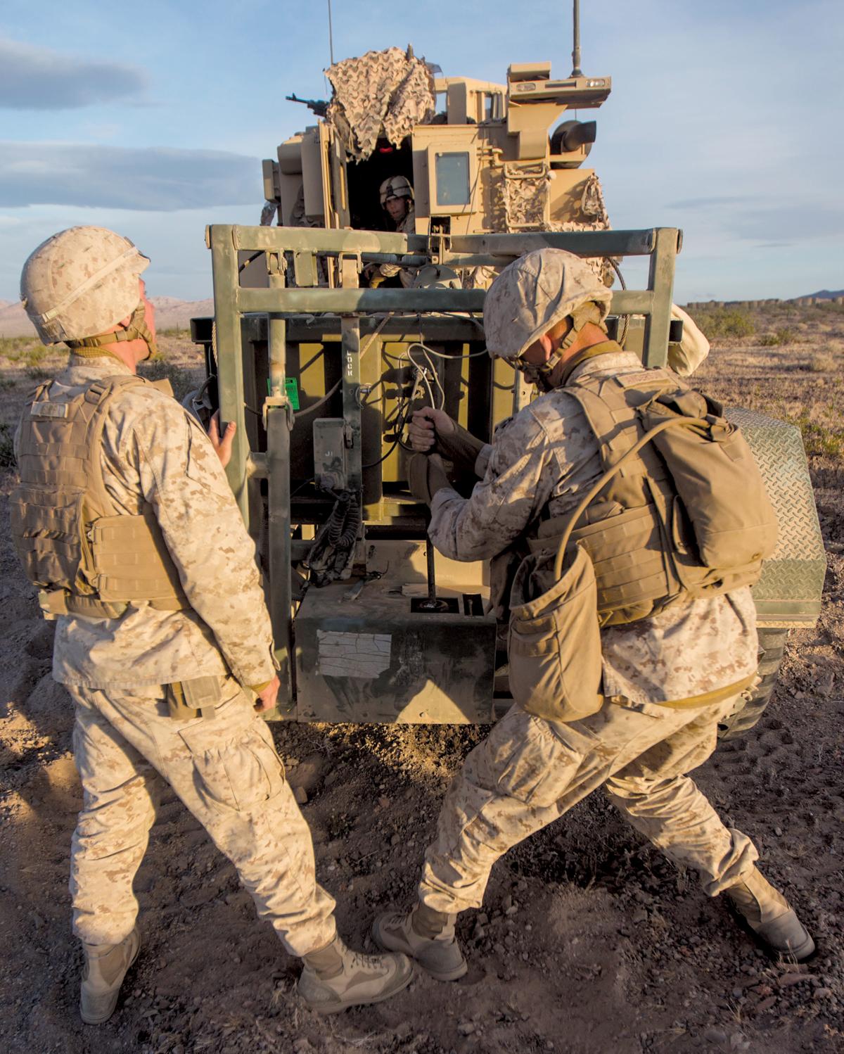 Marine Corps combat engineers prepare a line charge at Marine Corps Air-Ground Combat Training Center, Twentynine Palms, California. To best fight a peer enemy, Marine Corps combat engineers must be with the infantry—no lower than at the infantry regiment level and no smaller than as a reinforced engineer company.