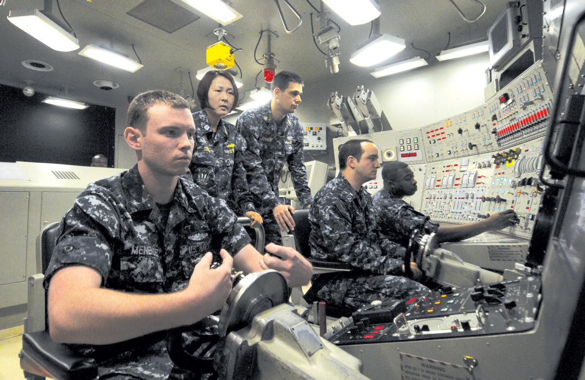A junior officer of the Blue crew on board the USS Ohio (SSGN-726) supervises a simulated dive as diving officer of the watch in the Ship Control Trainer at Trident Training Facility Bangor, Washington