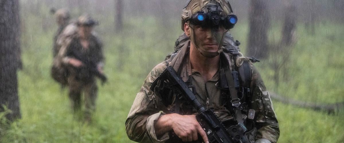 A Marine from Bravo Company, 2d Recon Battalion, 26th Marine Expeditionary Unit, moves through woodland areas during a rainstorm at Pelham Range, Anniston, Alabama. In planning exercises, the Marine Corps must generate realistic weather conditions that cause commanders and staffs to consider the environment as they think through the problems presented.