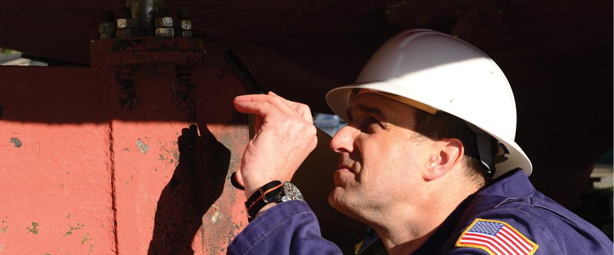 A marine inspector for Coast Guard Marine Safety Unit Portland, Oregon, inspects the propeller and rudder of the vessel Four Seasons. A data-driven marine inspection process would put the Coast Guard’s workforce in a better position to ensure the safe operation of the Marine Transportation System.