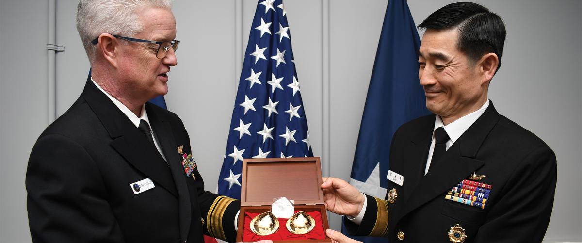 The Republic of Korea Chief of Naval Operations presents the Program Executive Officer for Unmanned Aviation and Strike Weapons with a gift. Tabletop exercises for wartime acquisition response plans should involve U.S. allies, as they often have the same systems, components, and support infrastructure and have undergone similar training.