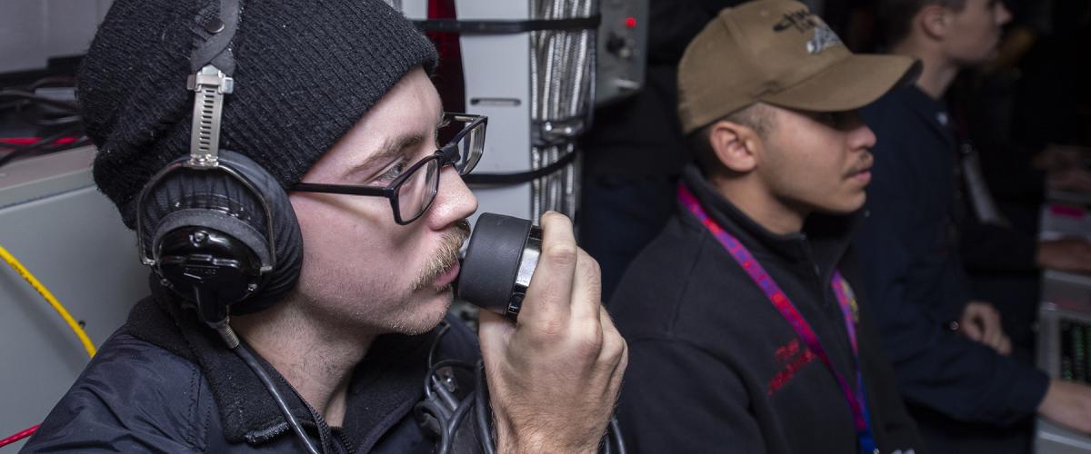 A fire-control technician passes information during a Mk 48 torpedo firing exercise on board the USS Chicago (SSN-721).  