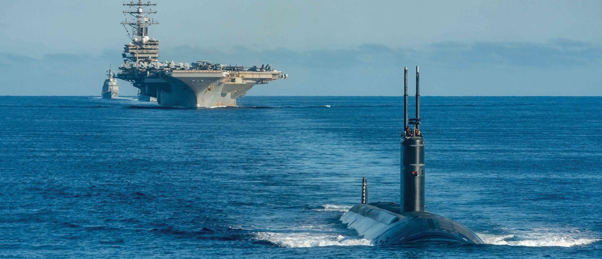 The USS Ronald Reagan (CVN-76), a Los Angeles–class fast-attack submarine, and Japan Maritime Self-Defense Force destroyer Asahi steam in formation in waters east of the Korean Peninsula.