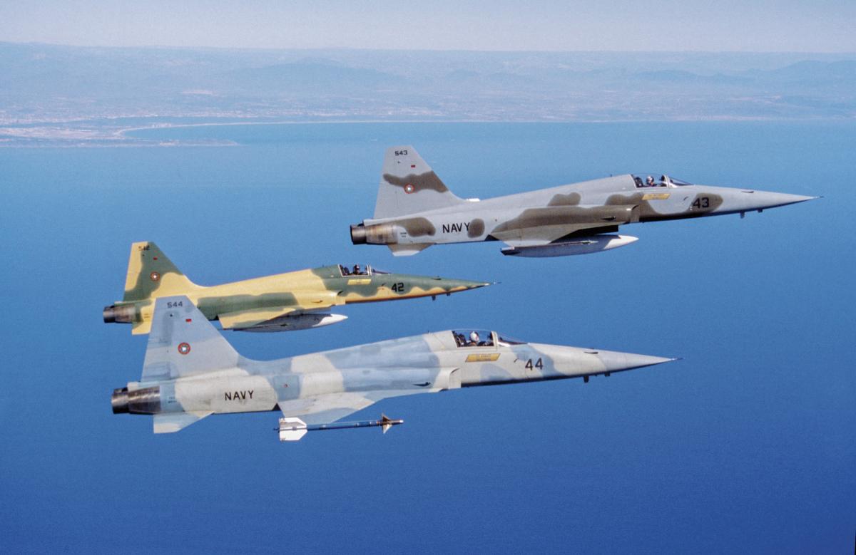 Three U.S. Navy F-5 Tiger II adversary aircraft in flight