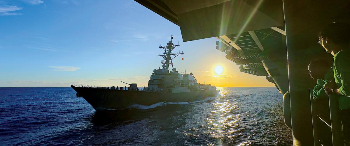 The Arleigh Burke–class guided-missile destroyer USS Daniel Inouye (DDG-118) comes alongside the Nimitz-class aircraft carrier USS Theodore Roosevelt (CVN-71) for replenishment on 25 January 2024. 