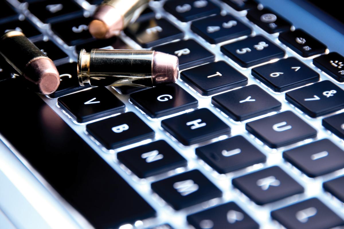 Bullet resting on laptop keyboard