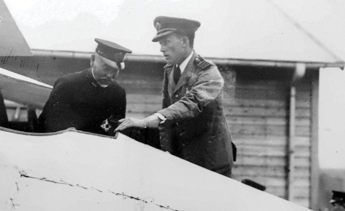 William Forbes-Sempill shows Japanese Admiral Heihachiro Togo the interior of a British-built Sparrowhawk fighter in 1921.