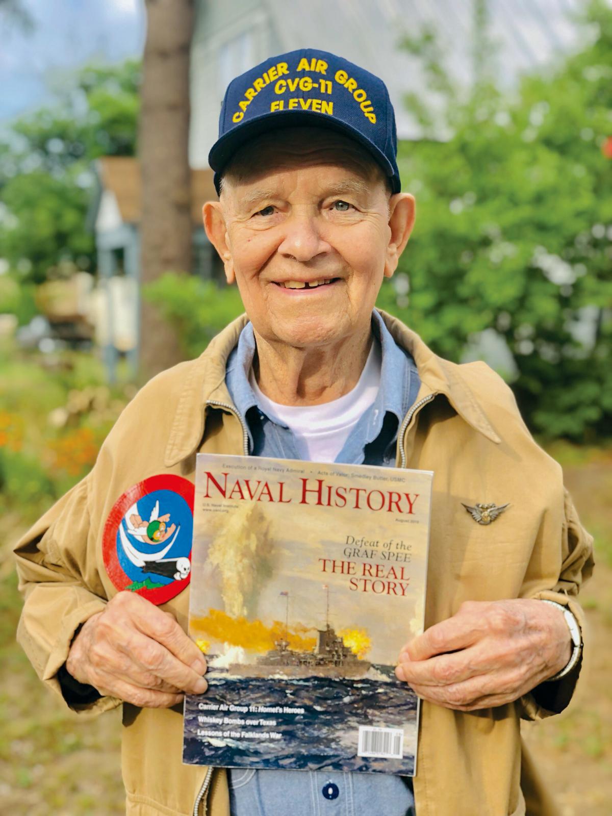 Verg Bloomquist posing with the August 2019 issue of Naval History