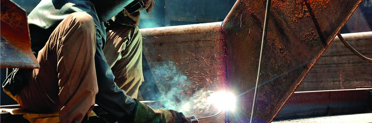 A welder working on a ship