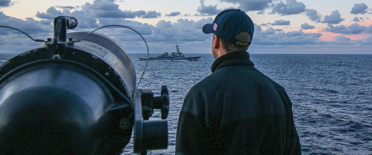 An ensign stands watch on board the USS Ross (DDG-71). While recent changes to junior surface warfare officer training were designed to emphasize bridge watchstanding, they do not address the problem of too many ensigns assigned to each ship.