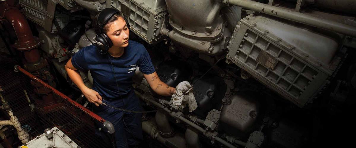 A fireman checks the oil on the main engine of the USCGC Stratton (WMSL-752) in the South China Sea in June 2023. 