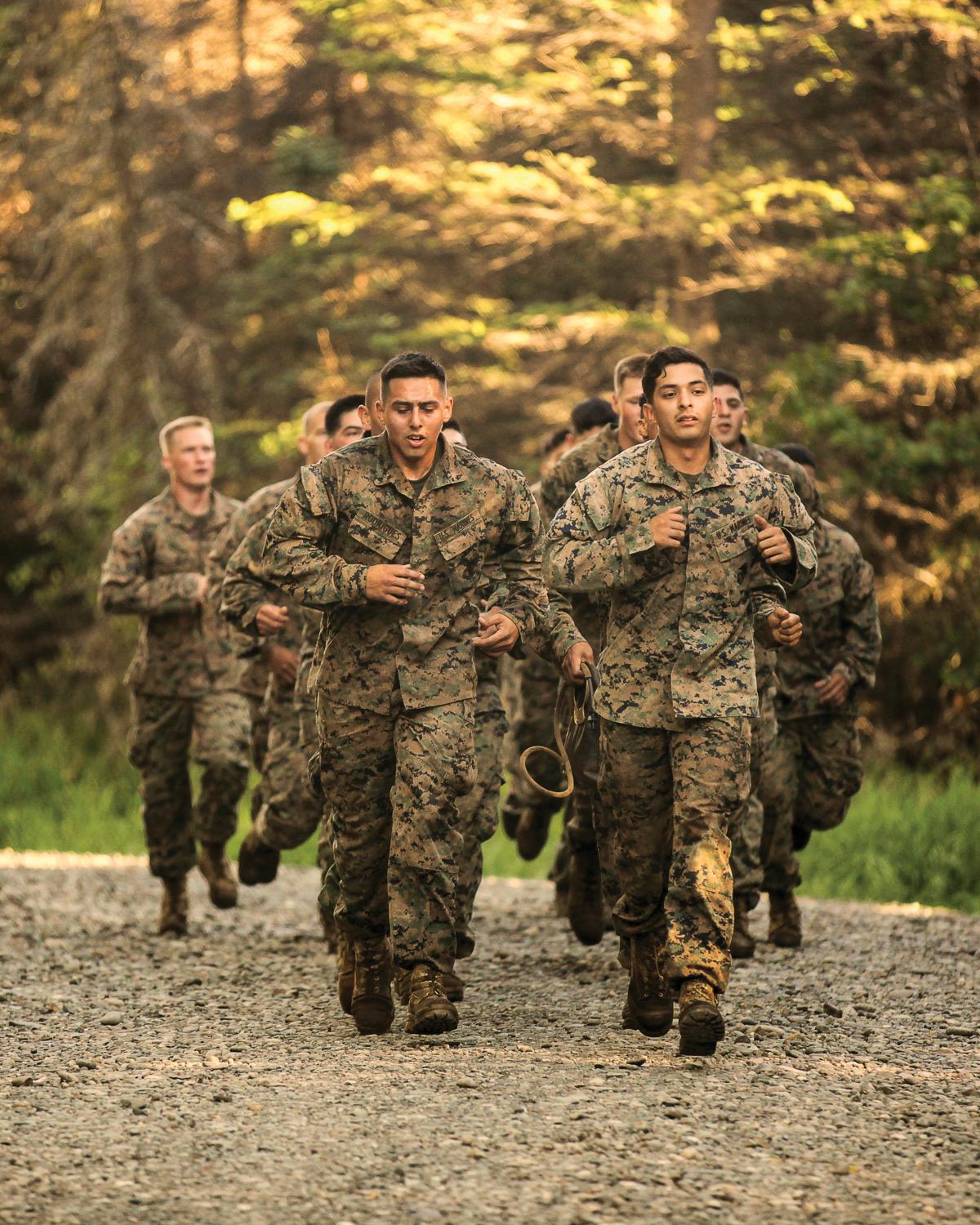 Marines running to the next event in an obstacle course 